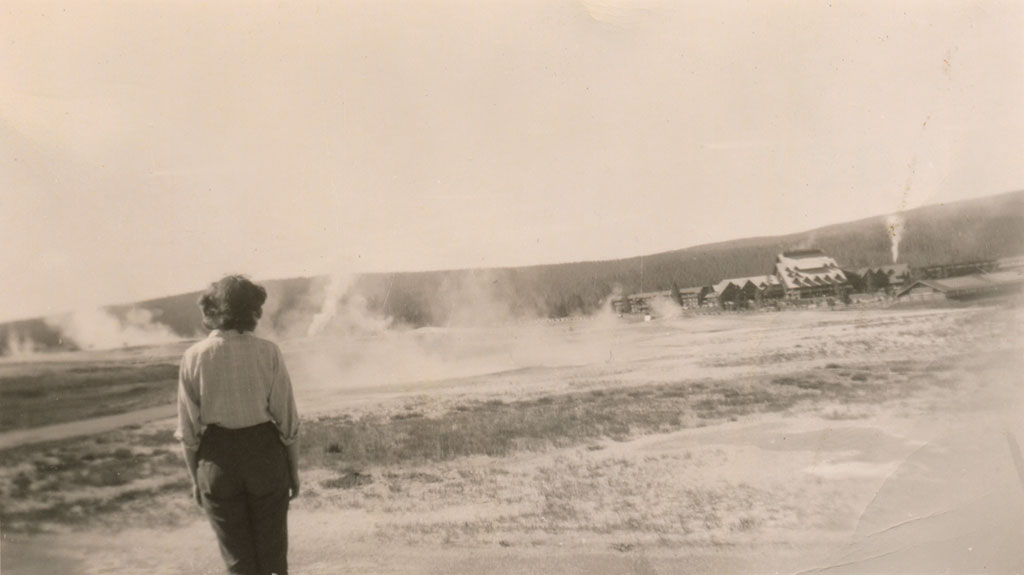 Illustration from the novel theMystery.doc by Matthew McIntosh. Sepia-toned photograph of a woman, seen from behind, watching steaming geysers at Yellowstone National Park. (c) Mrs. Matthew McIntosh.